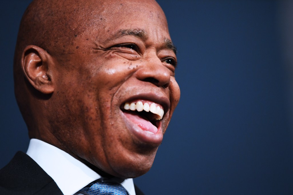Close-up of Mayor Eric Adams laughing.