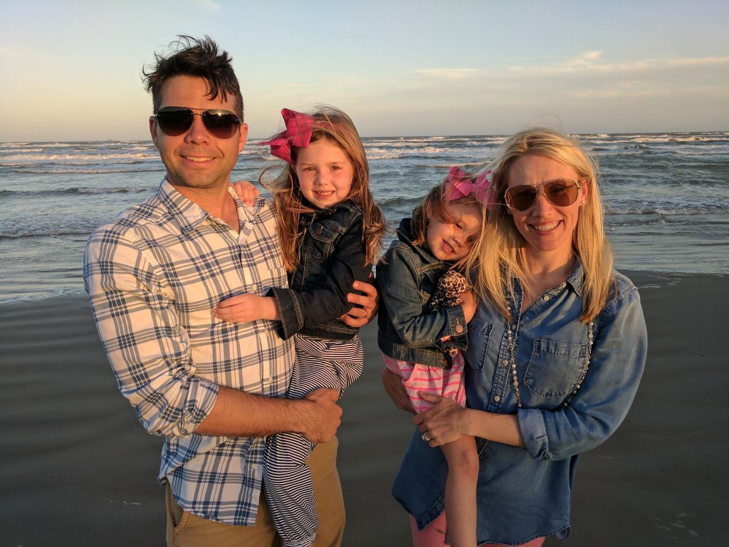 Family on the beach at sunset.