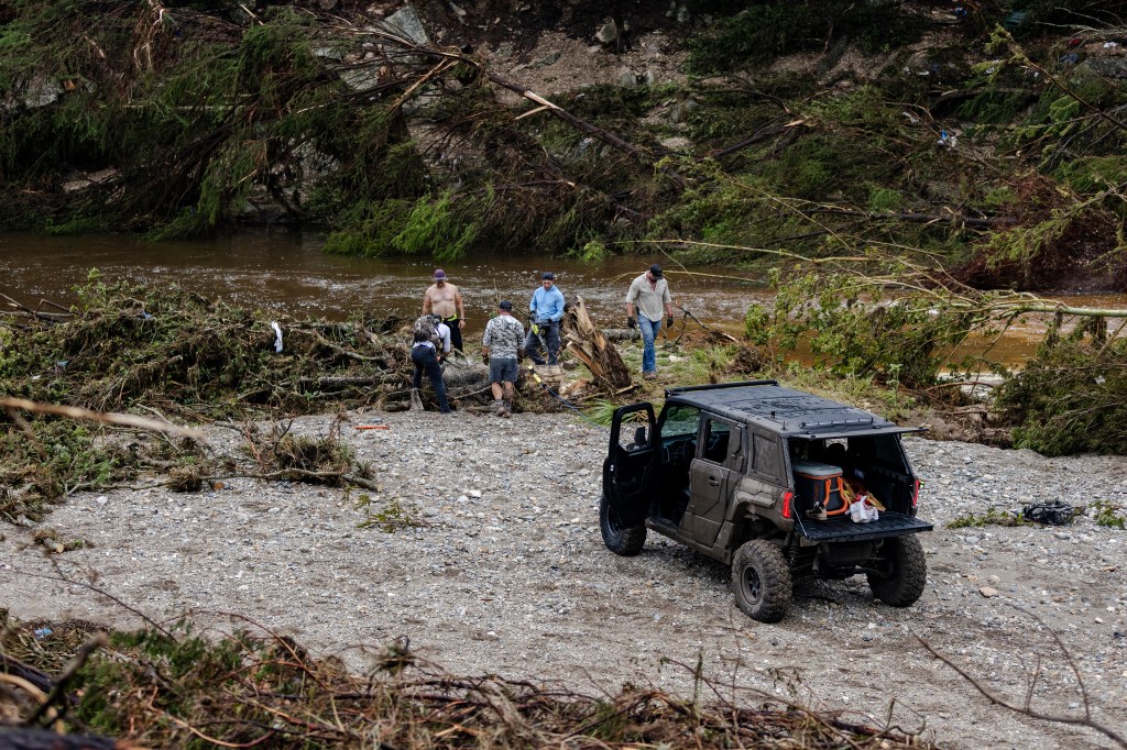 Search and recovery workers clearing debris after flash flooding.