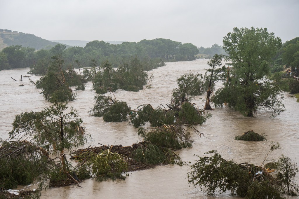 Trees emerge from flood waters along the Guadalupe River on July 4, 2025 in Kerrville, Texas.
