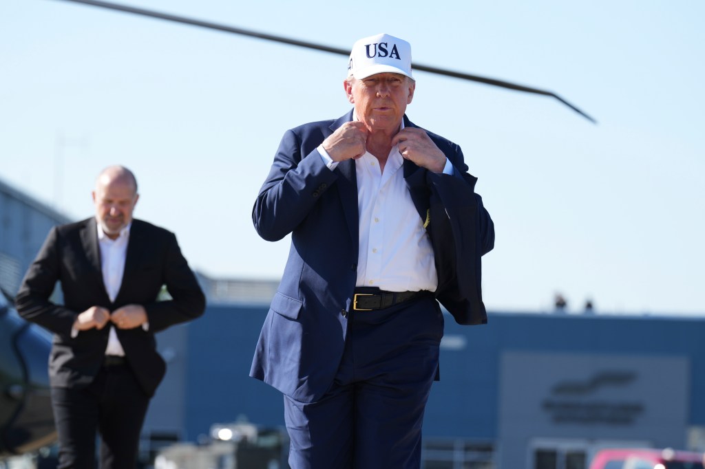 Donald Trump adjusting his jacket.