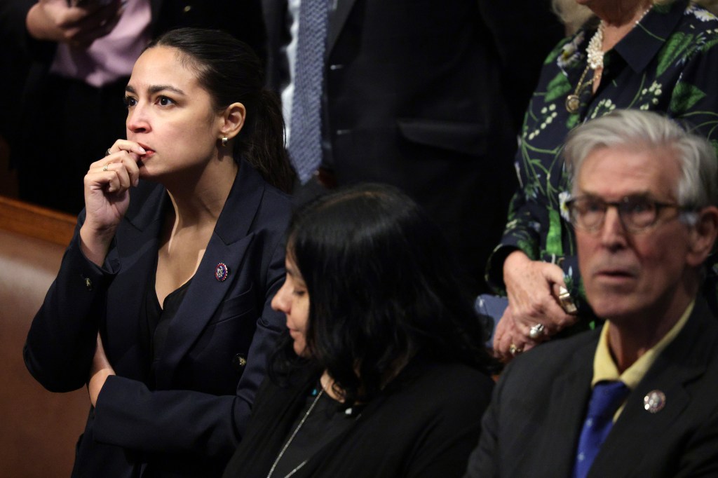 Rep. Alexandria Ocasio-Cortez watching a vote count in the House of Representatives.