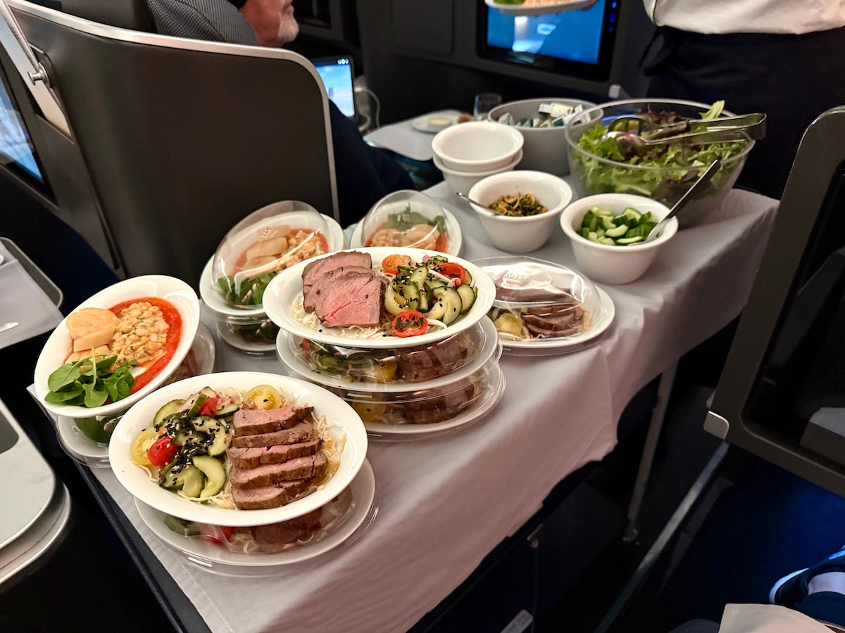 Trolley stacked with plates of food on plane