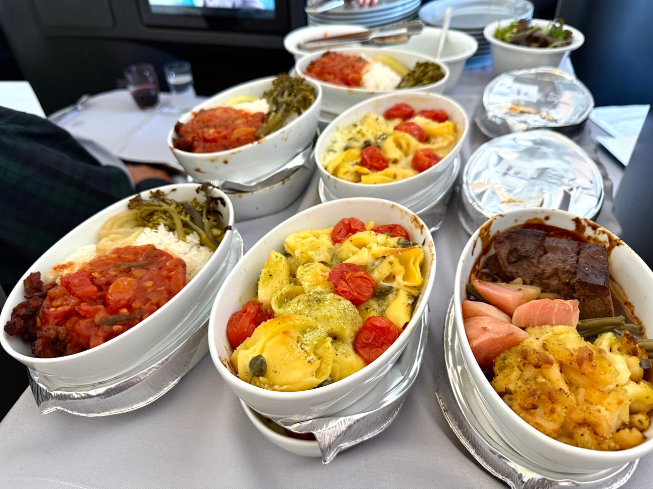 Plates on a plane piled with meals