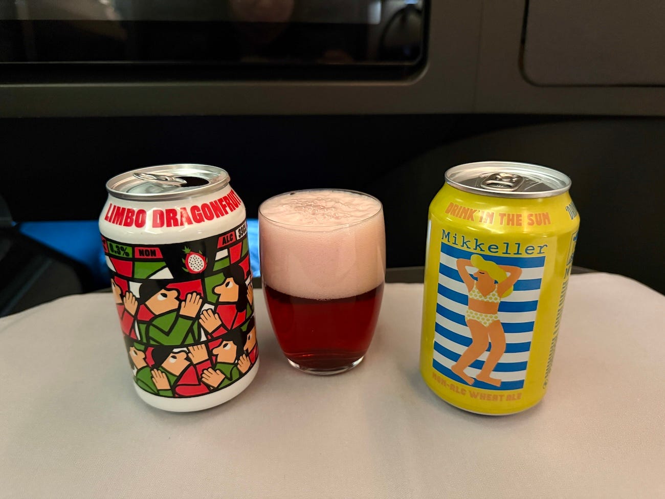 Mikkeller's non-alcoholic canned beverages in cans on plane tray .