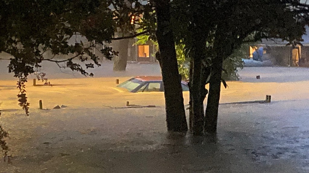 Flooded Chapel Hill street with a submerged car.
