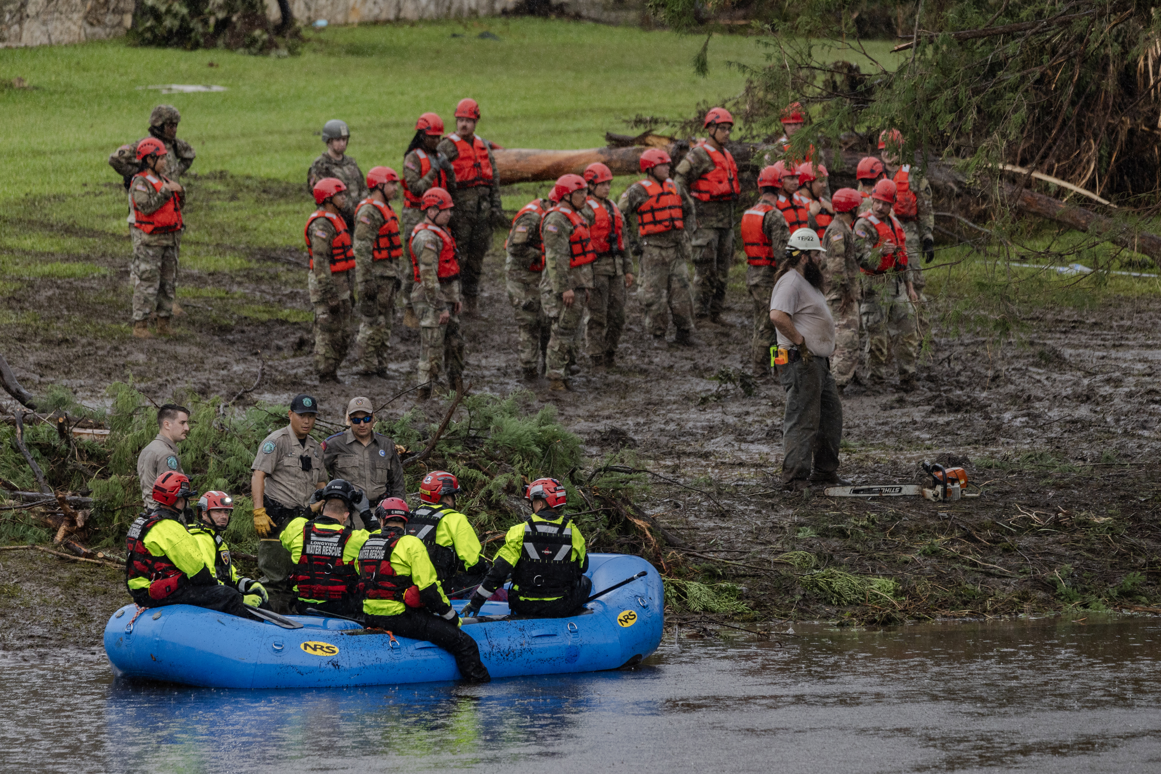 Search and recovery workers dig through debris after Texas floods
