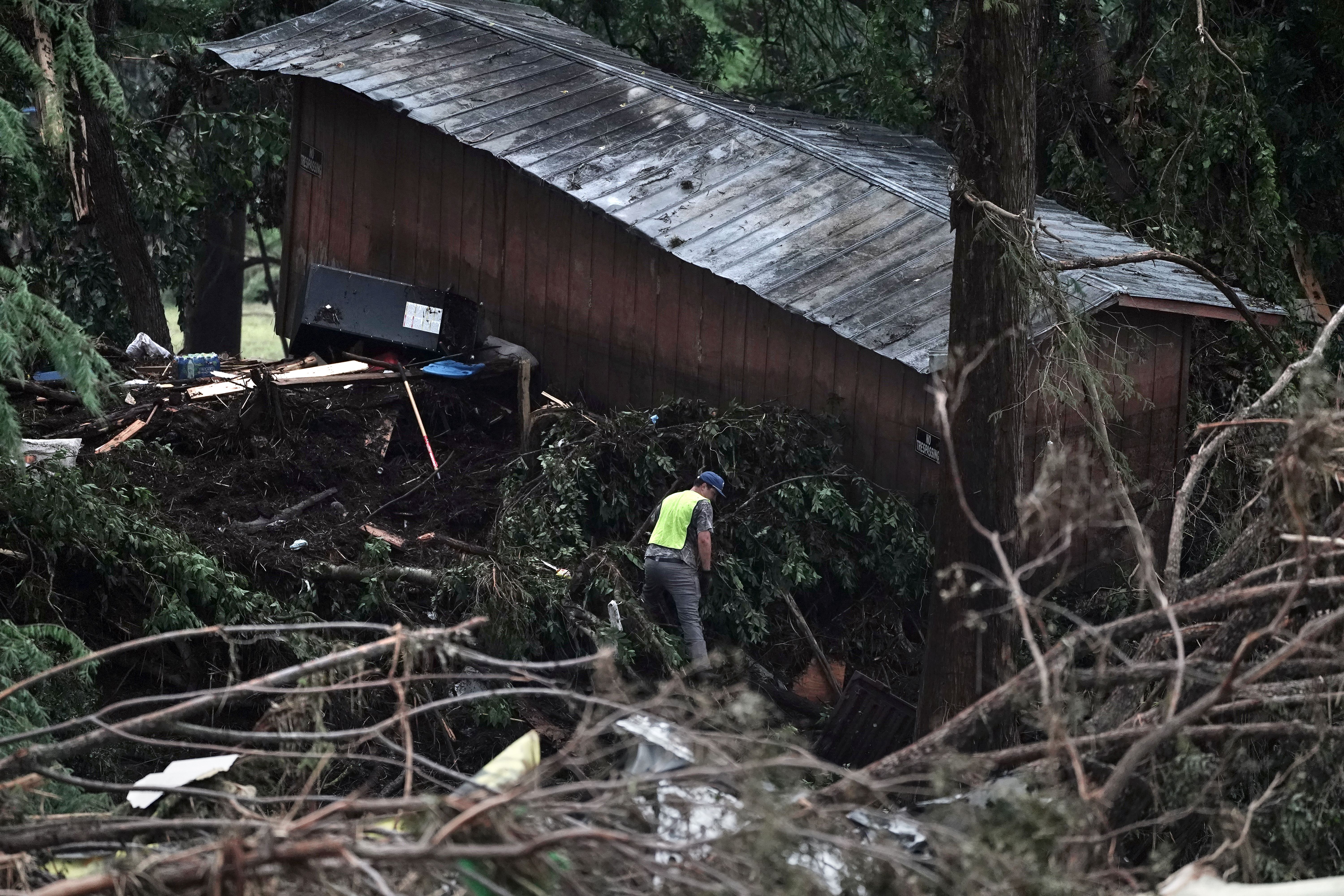 First responders searching a building washed ashore from Texas flood waters