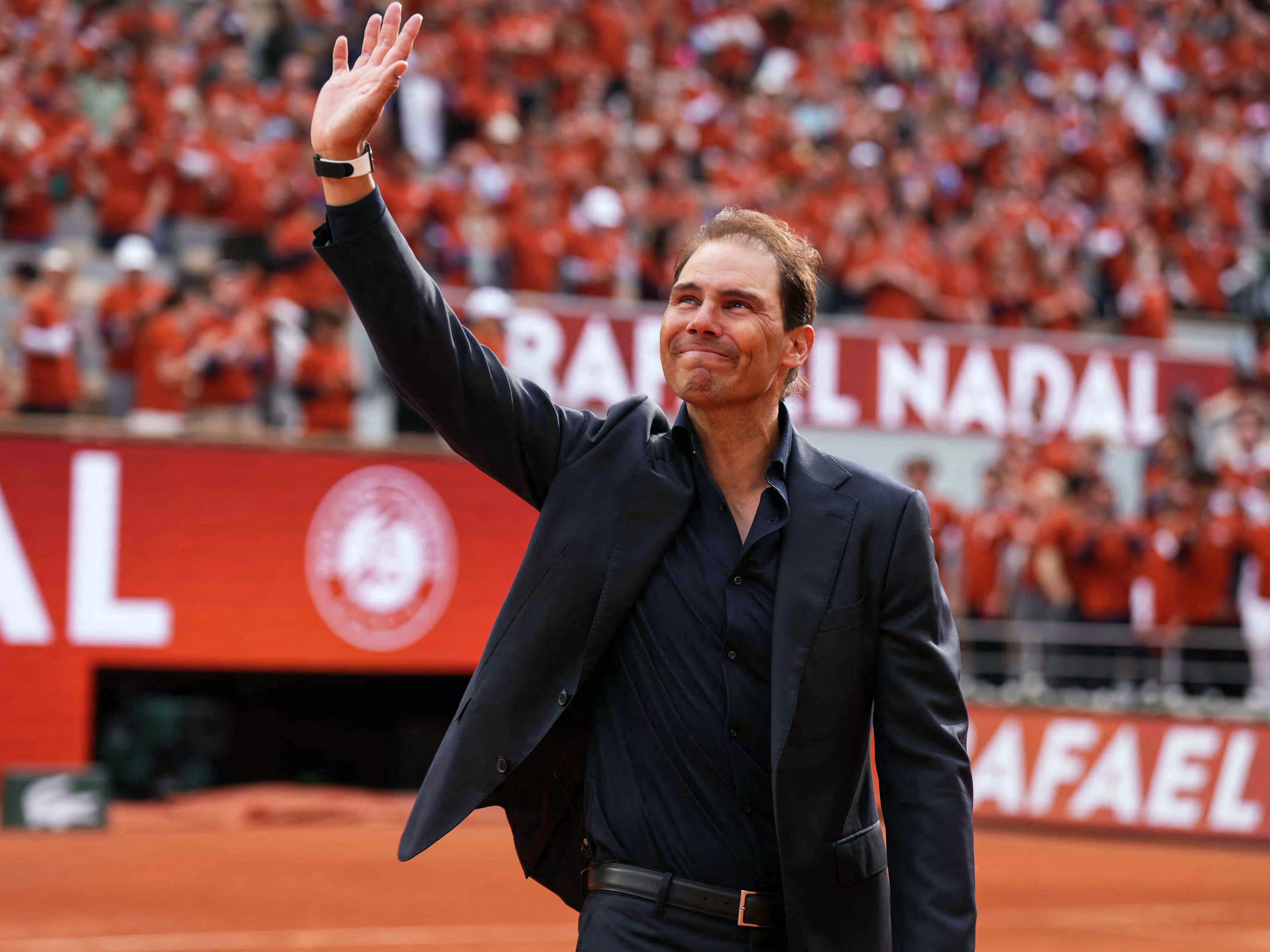 Former Spanish player Rafael Nadal waves to the crowd during a ceremony honouring his career during the French Open tennis tournament on Court Philippe-Chatrier at the Roland-Garros Complex in Paris on May 25