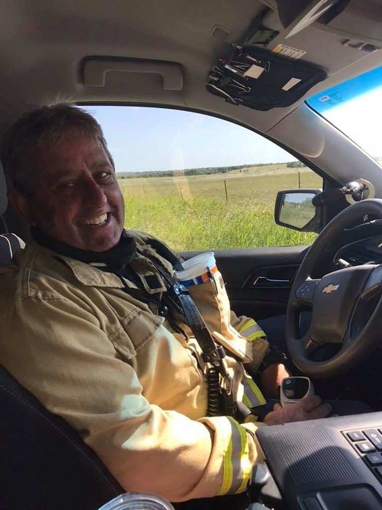 Photo of Michael Phillips, a volunteer fire chief, sitting in his vehicle.