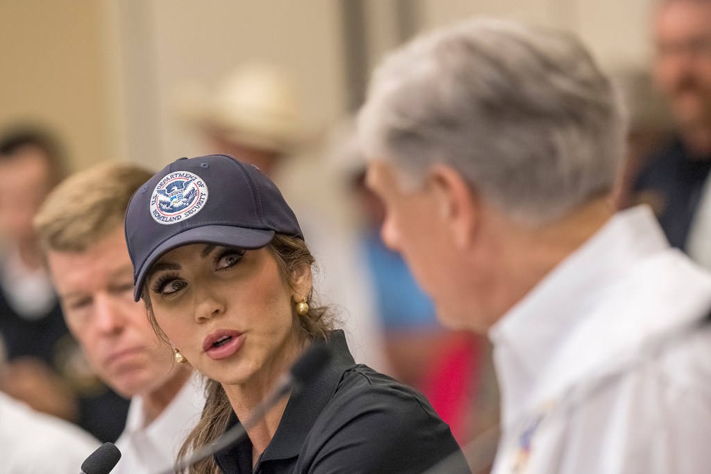 Kristi Noem and Greg Abbott at a press conference.