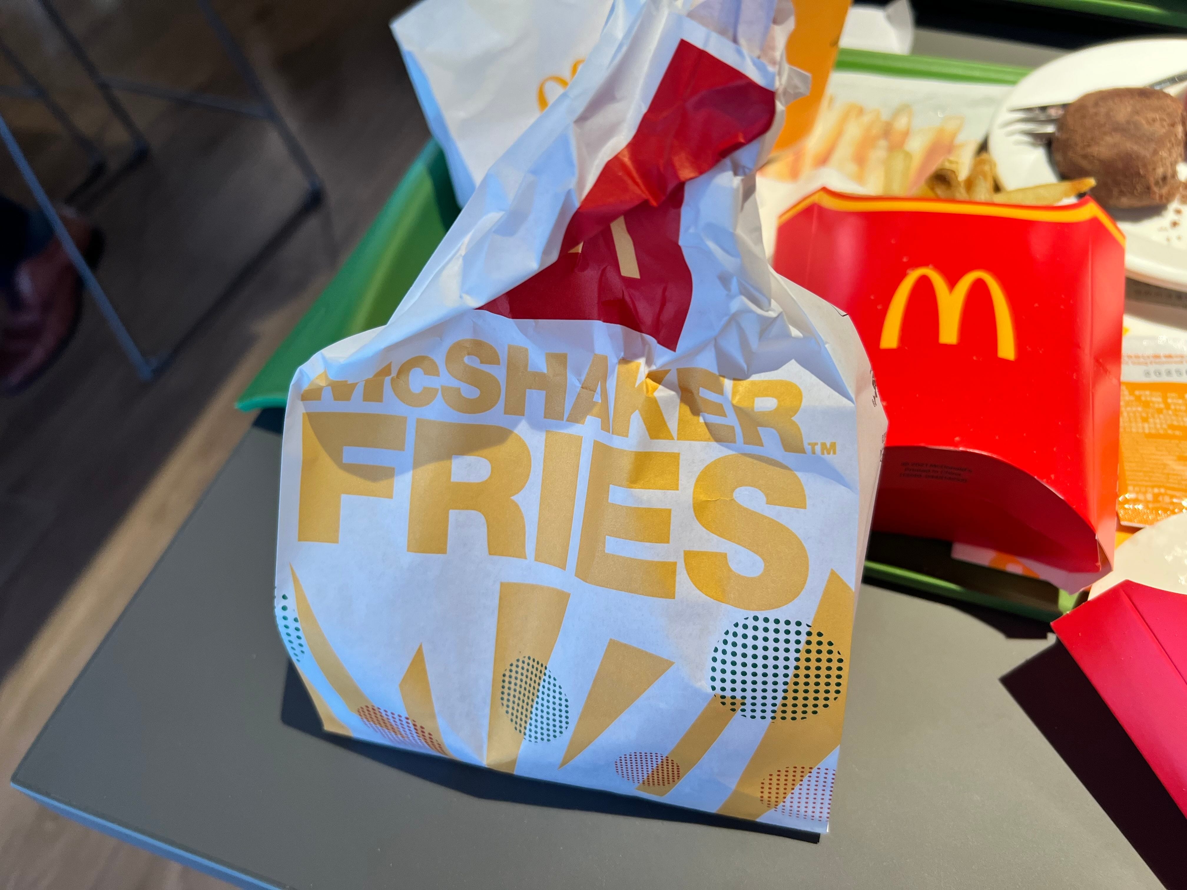 Shake Fries are regular McDonald's fries served with a seasoning packet and a paper bag.