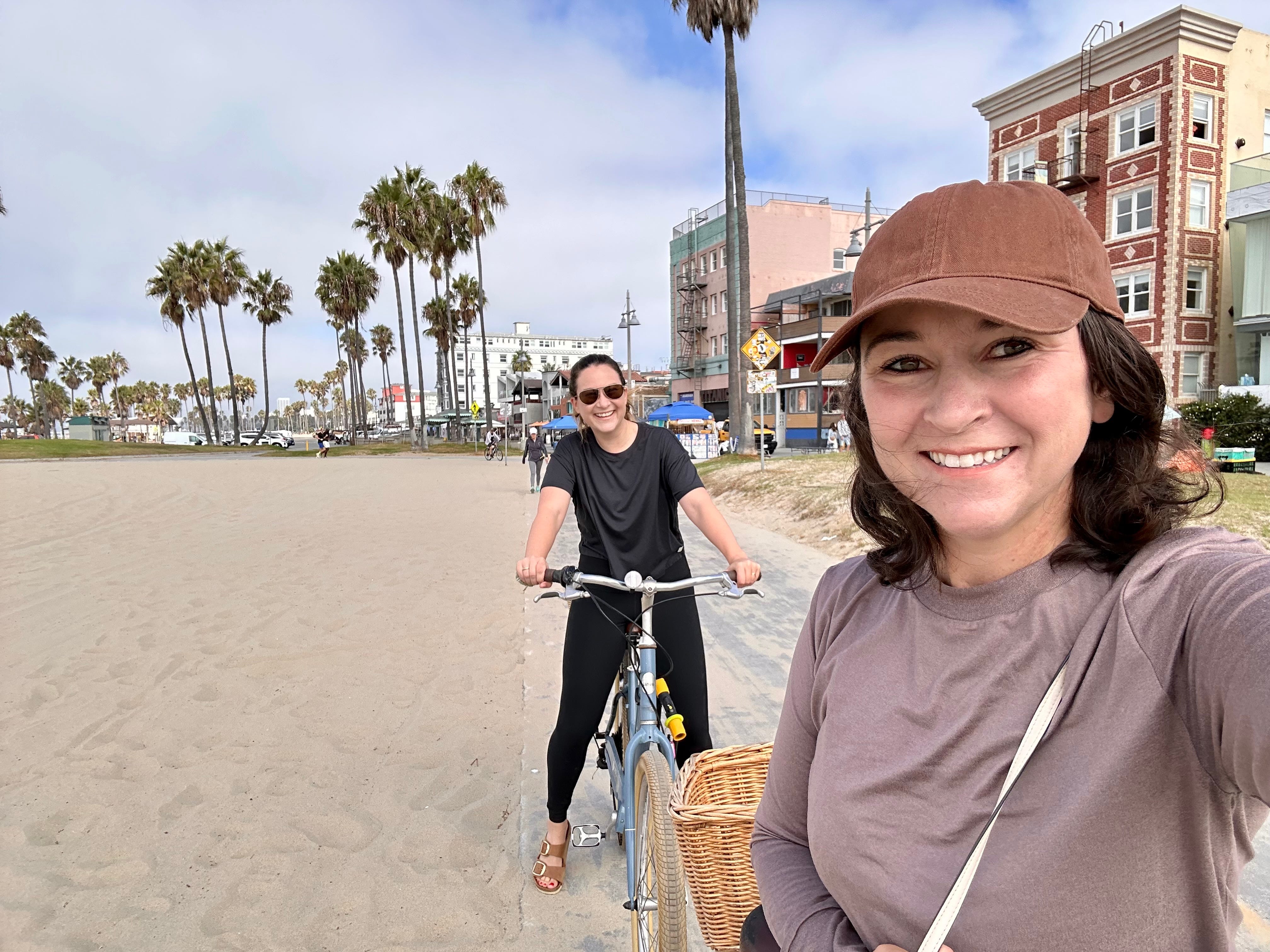 The author and her sister riding bikes on the beach.
