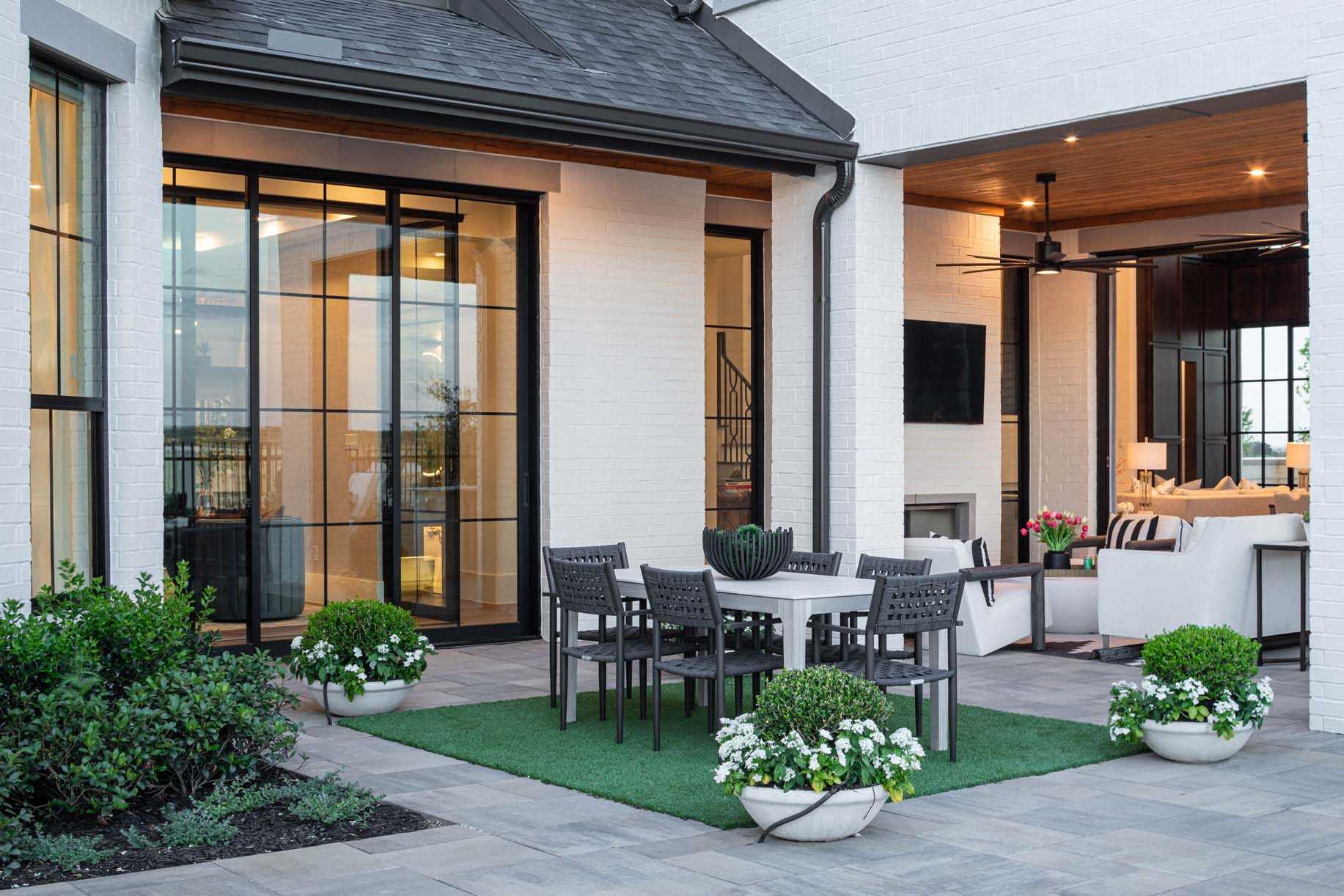 A Highland Homes backyard with a patio and dining space.