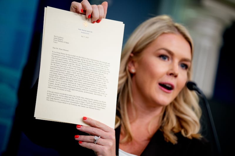 White House press secretary Karoline Leavitt holds up a copy of a letter to Japan, signed by U.S. President Donald Trump, announcing 25% tariffs beginning on August 1