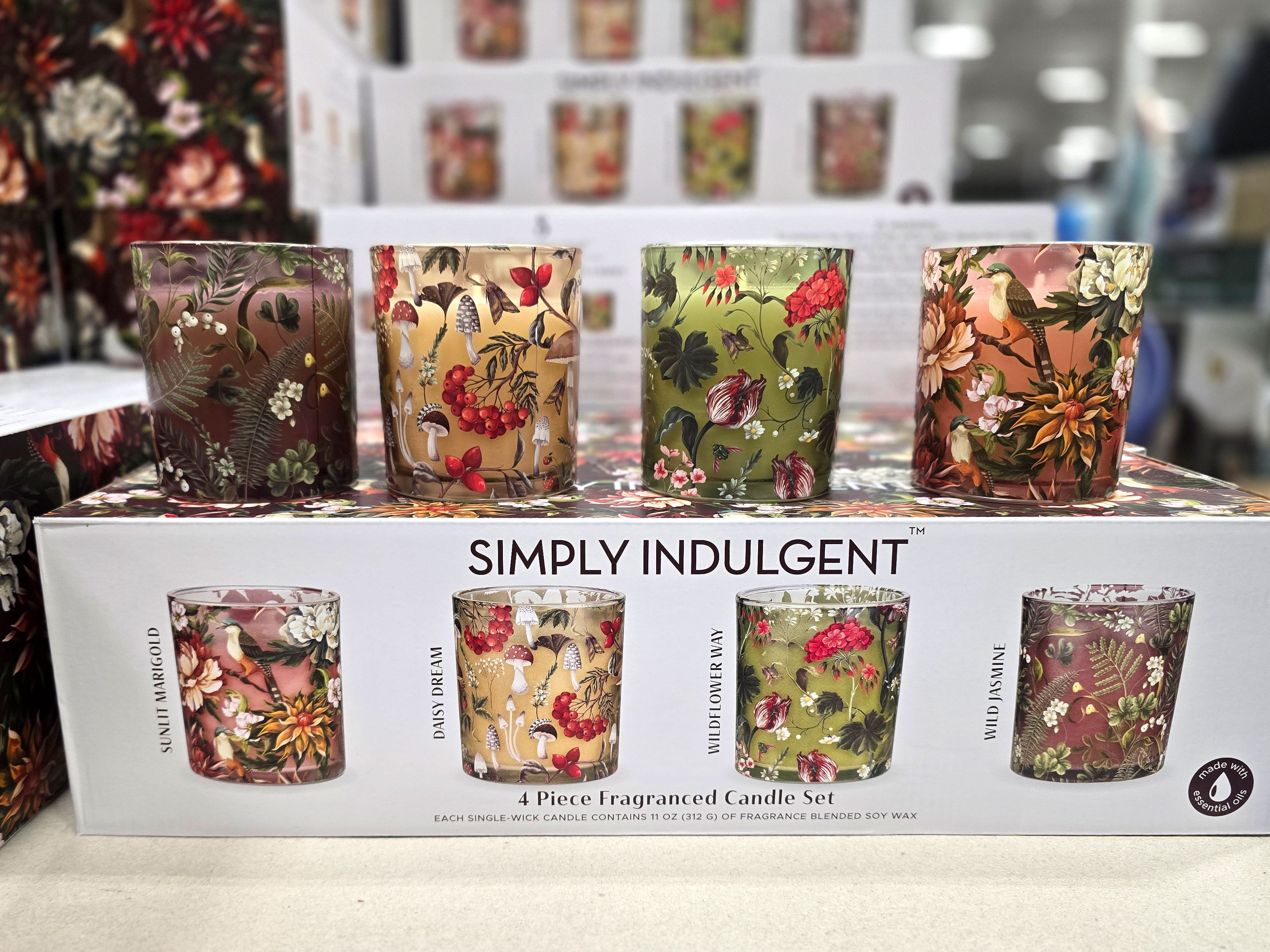 A box of four floral candles, with the actual product displayed on top.