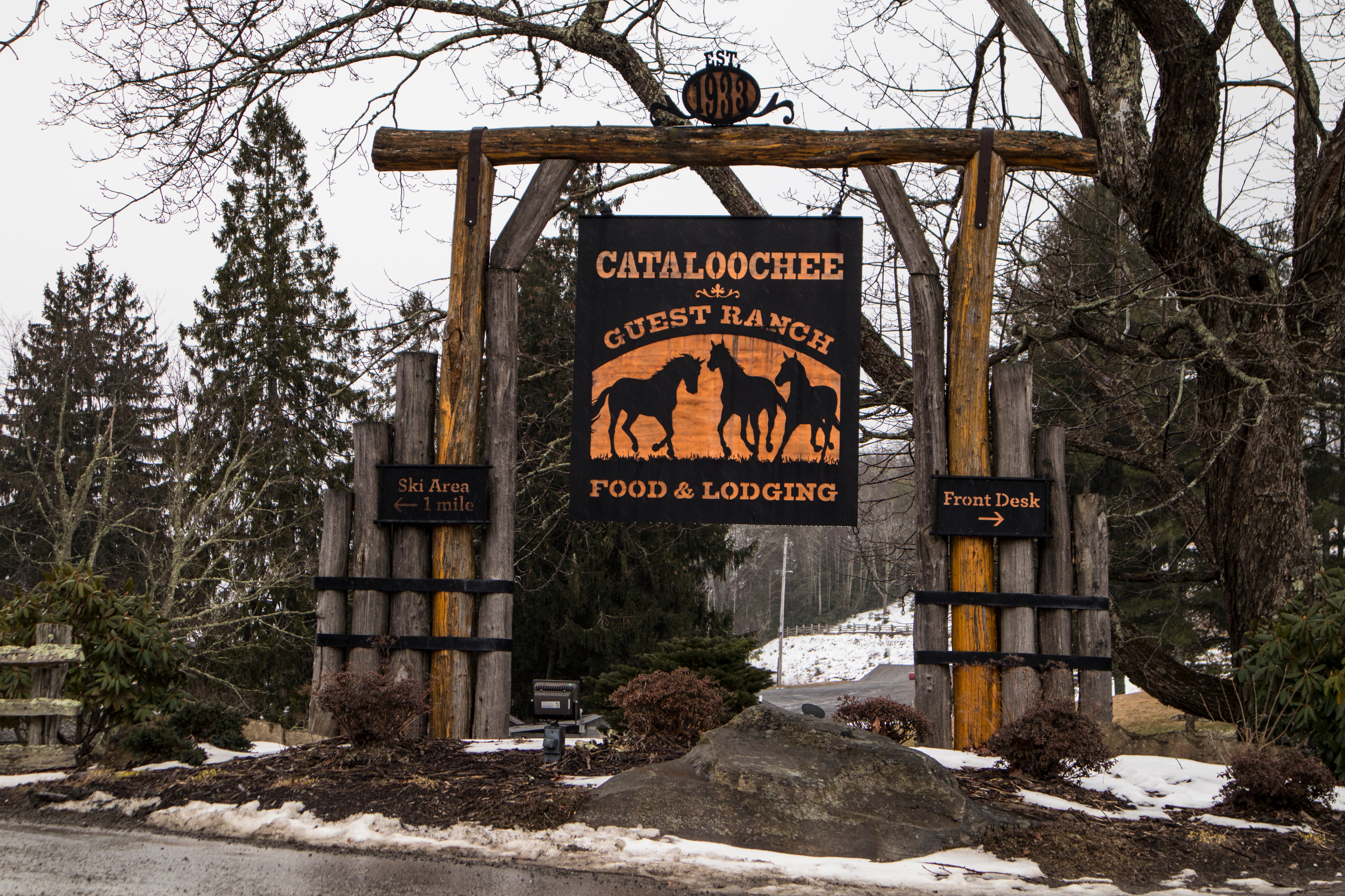 Cataloochee Guest Ranch sign in front of wood gate