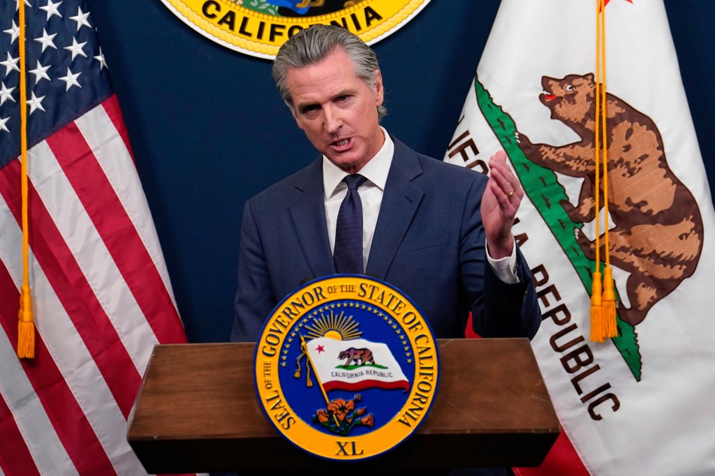 Governor Gavin Newsom speaking at a podium.
