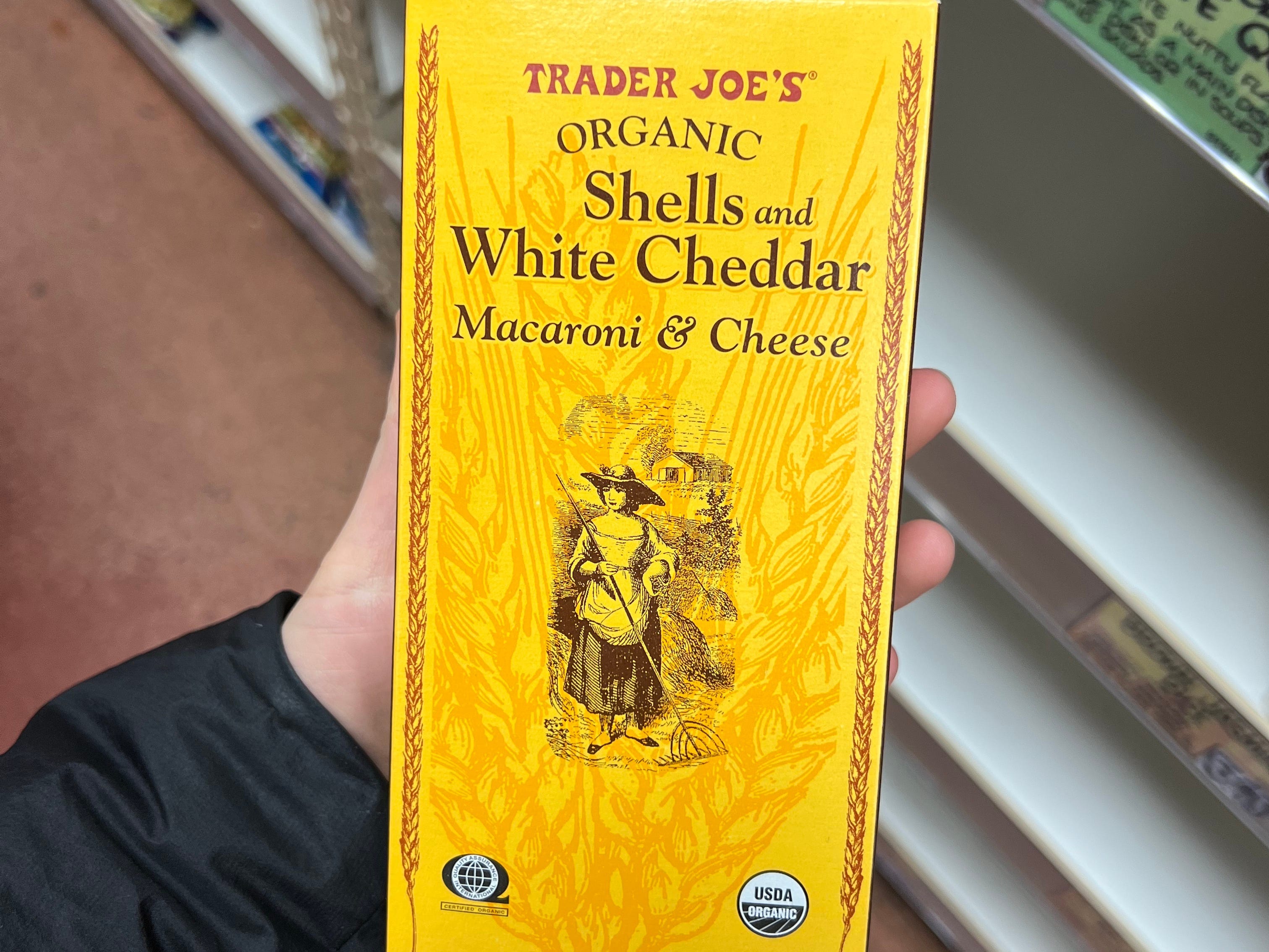 The writer holds a box of mac and cheese