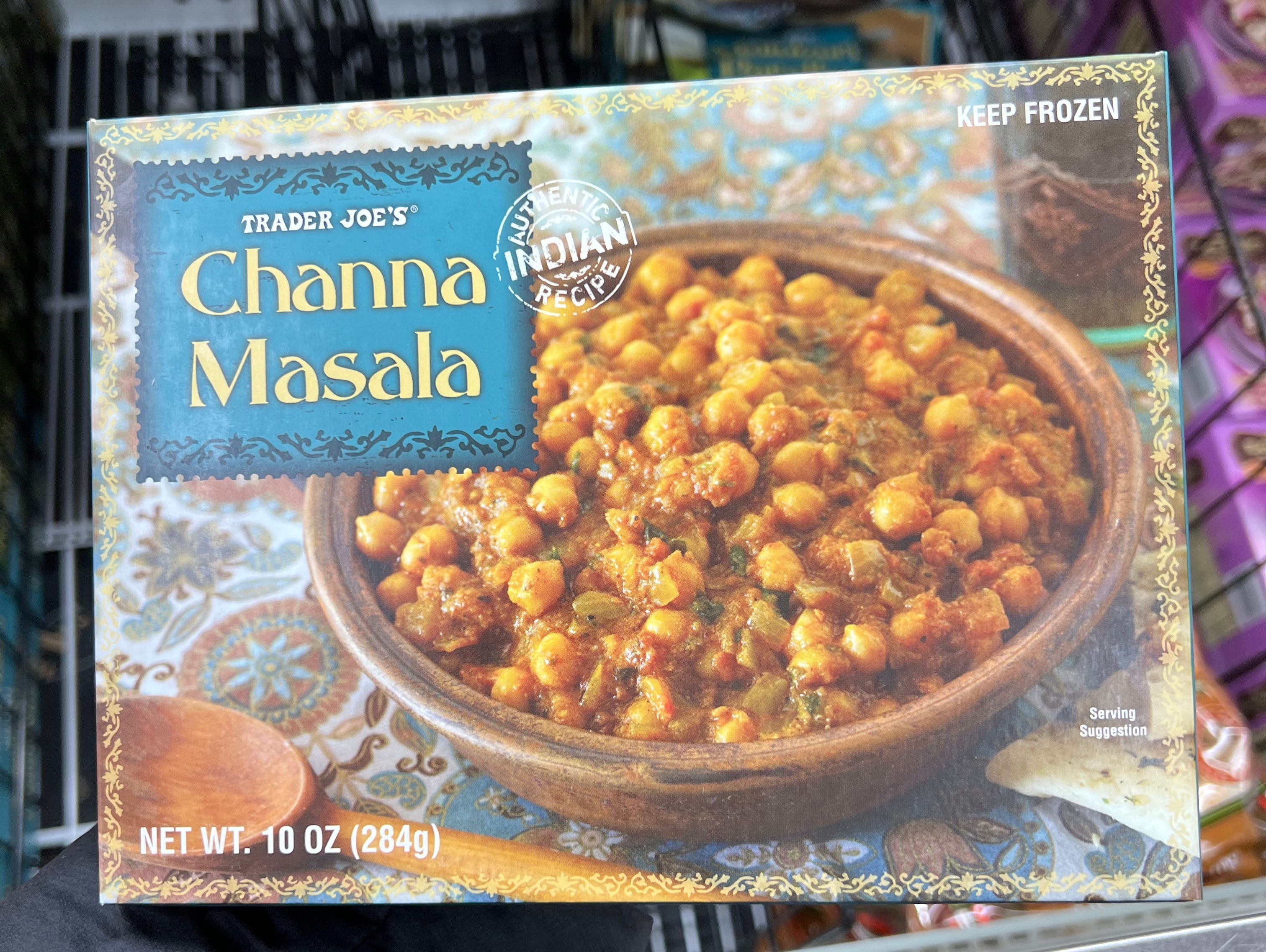 The writer holds up box of chana masala with chickpeas on the front