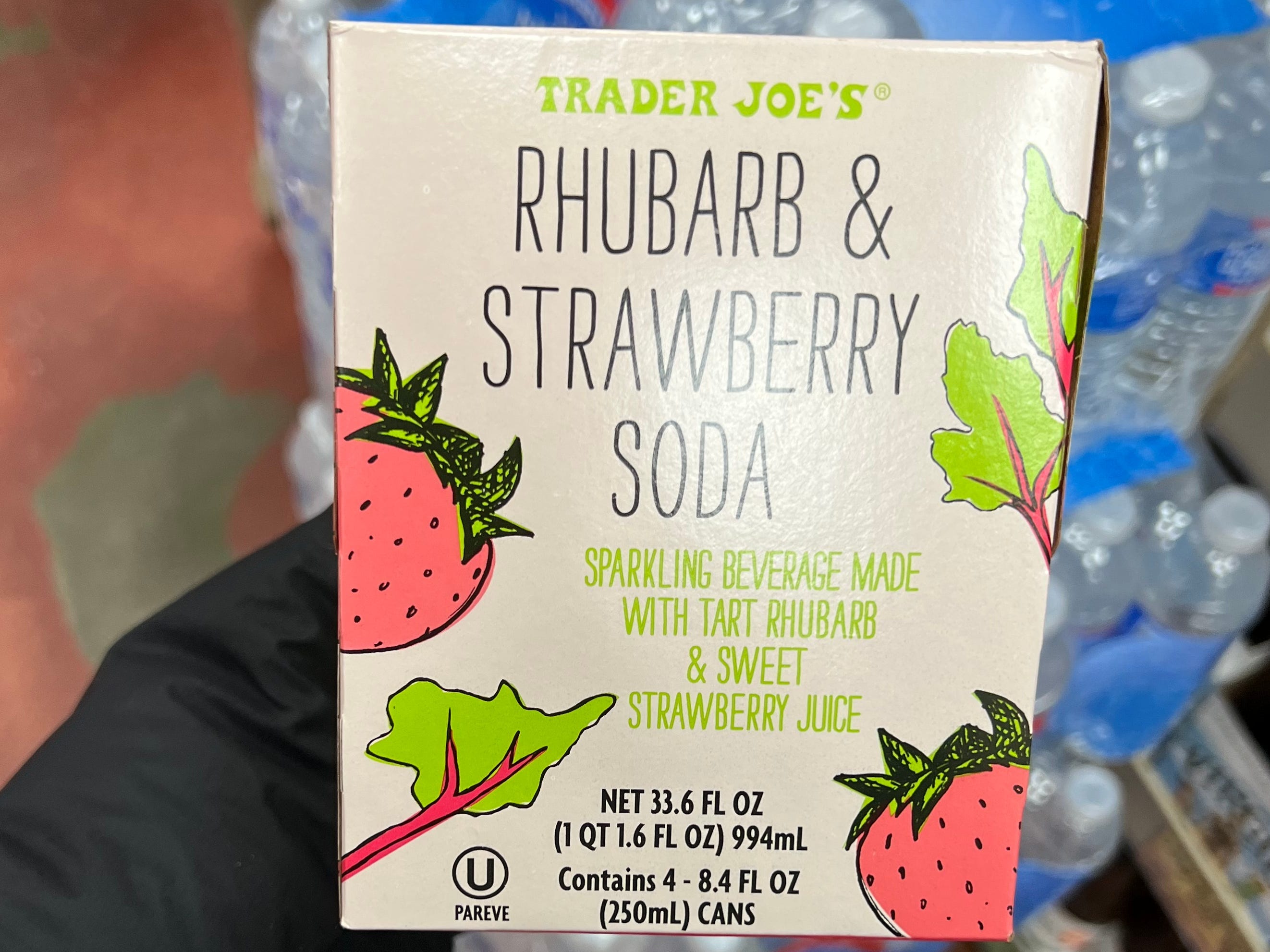 The writer holds a box of rhubarb and strawberry soda