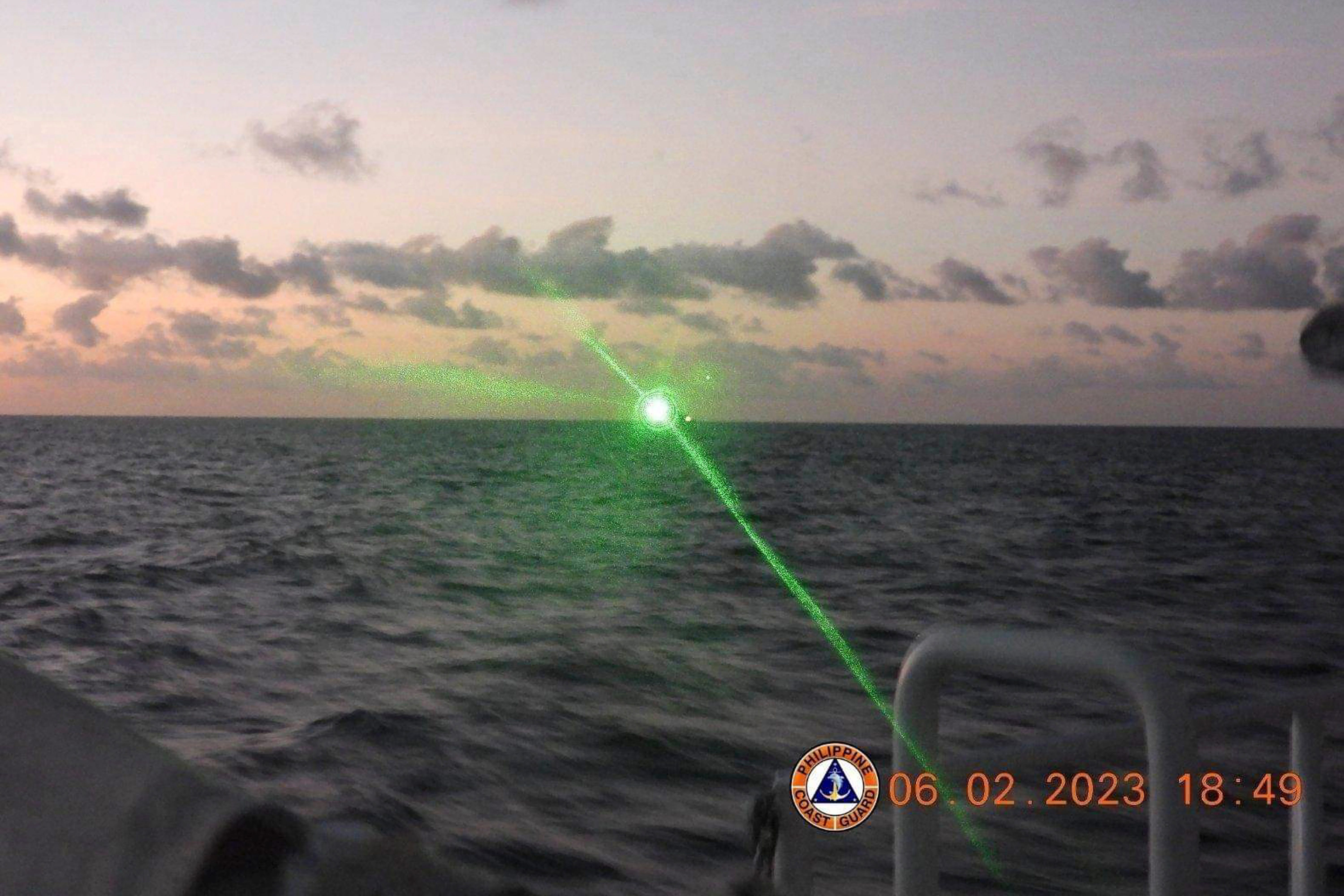 FILE - This photo provided by the Philippine Coast Guard shows a green military-grade laser light from a Chinese coast guard ship in the disputed South China Sea, Feb. 6, 2023.