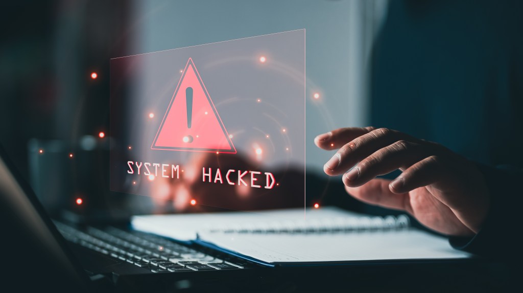System hacked alert on a laptop screen.