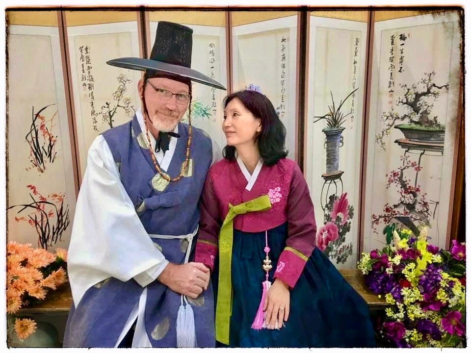 A couple posing in traditional South Korean attire.