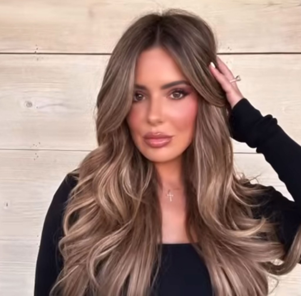 Brielle Biermann posing with a hand on her head.
