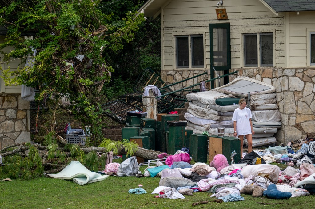 People sift through children's belongings left behind at Camp Mystic on July 7, 2025.