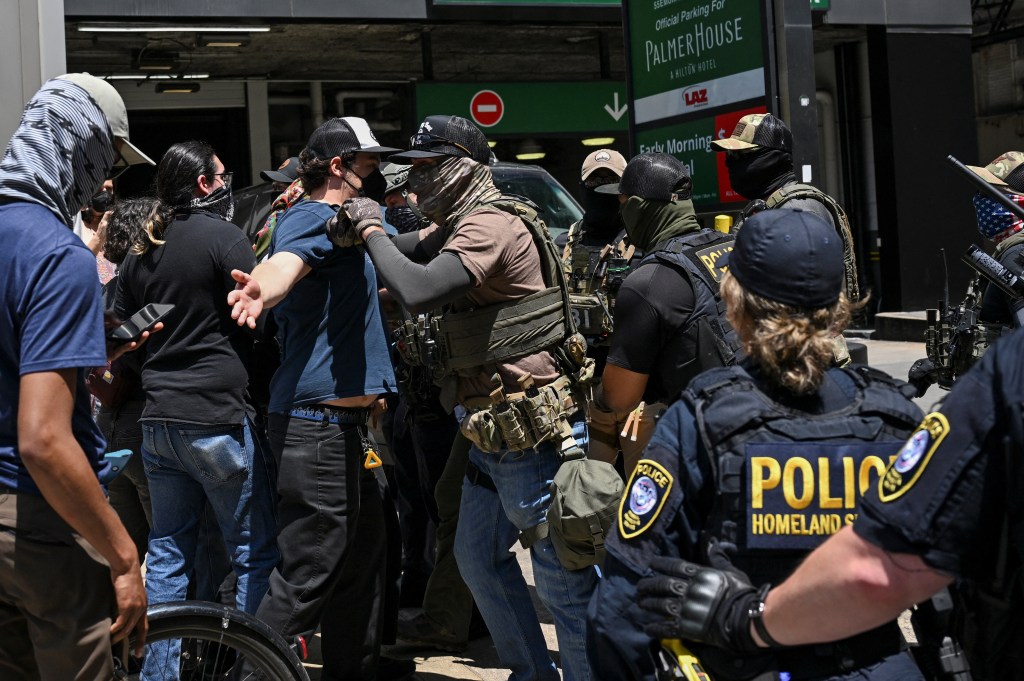 Anti-ICE protesters are stopped by federal agents outside a building housing an immigration court in Chicago on June 16, 2025.