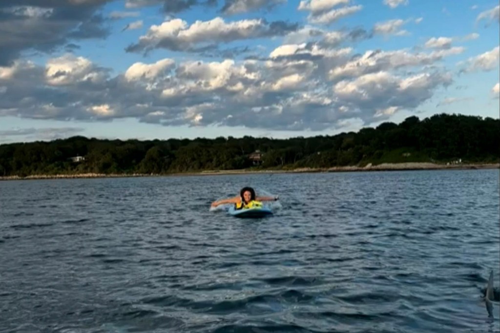 The dorsal fin of a great white shark pops out of the water near Margaret Bowles in Woods Hole, Mass. on July 4, 2025. 