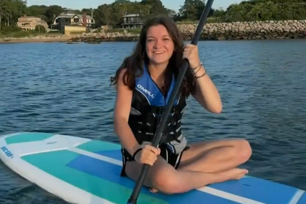 Maddie Cronin sits on her paddleboard during her outing with Bowles.