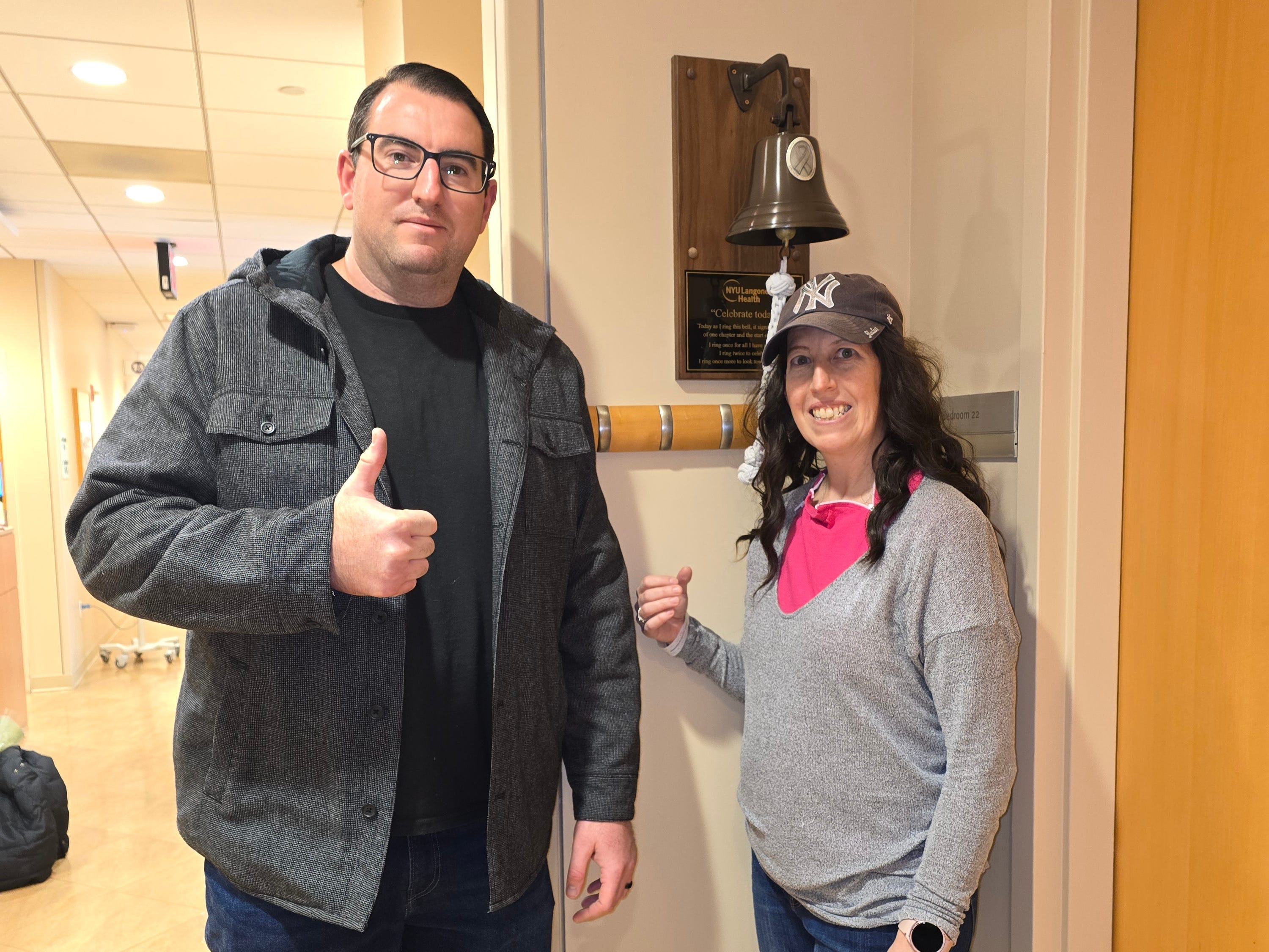 Katie Asturizaga ringing a bell at the end of her cancer treatment.