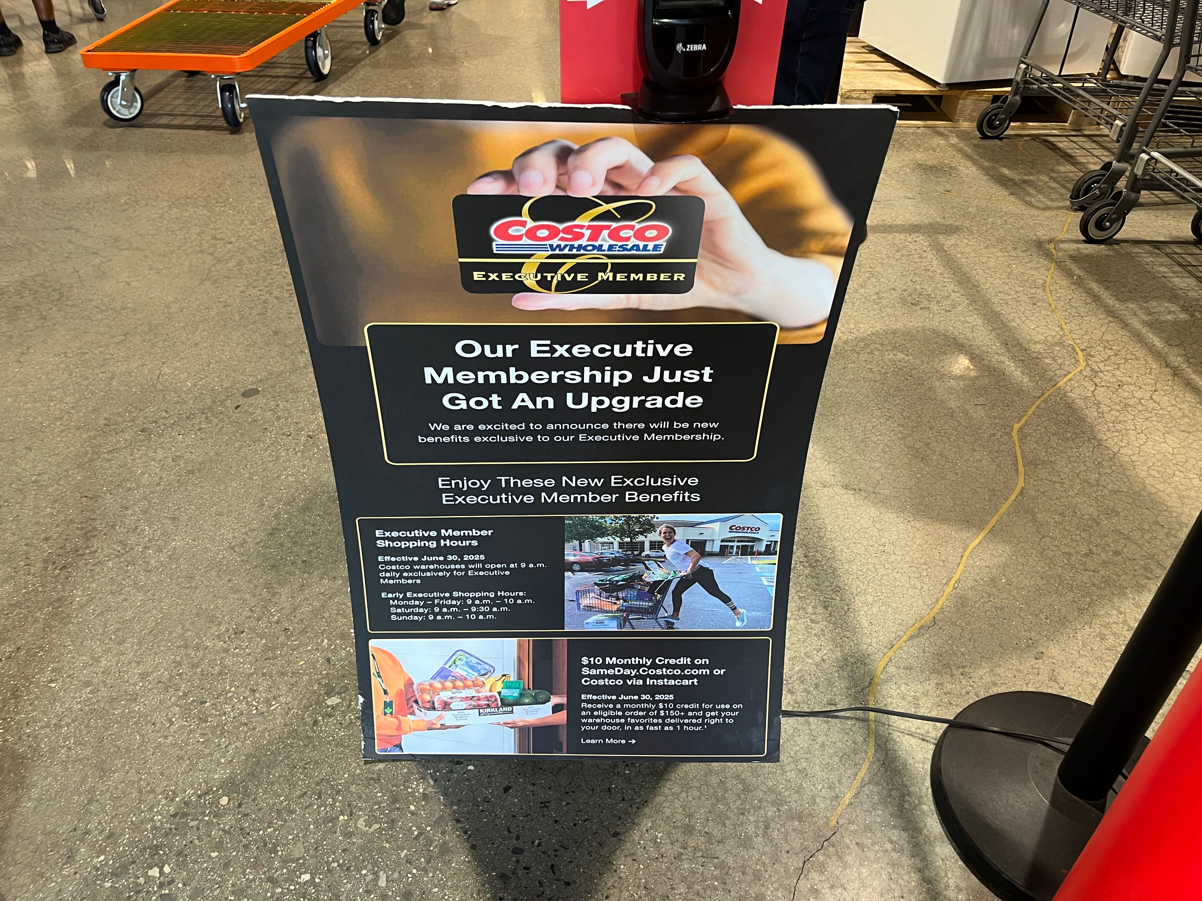 A sign advertising the new perks of Costco's executive membership.