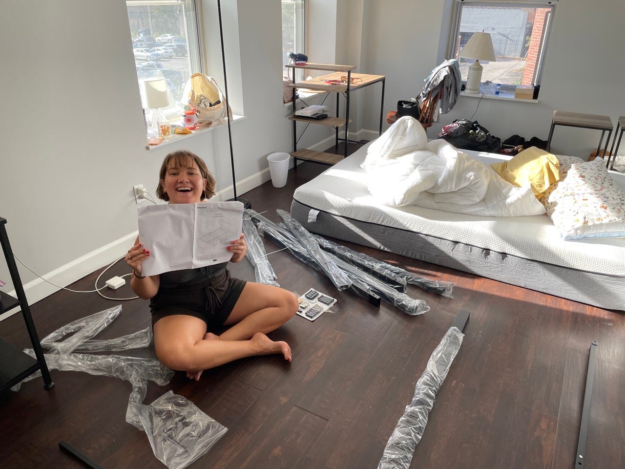 Author Katie Lemon on floor of home with furniture parts