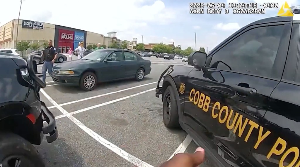 Bodycam footage of police rescuing children from a hot car in a mall parking lot.