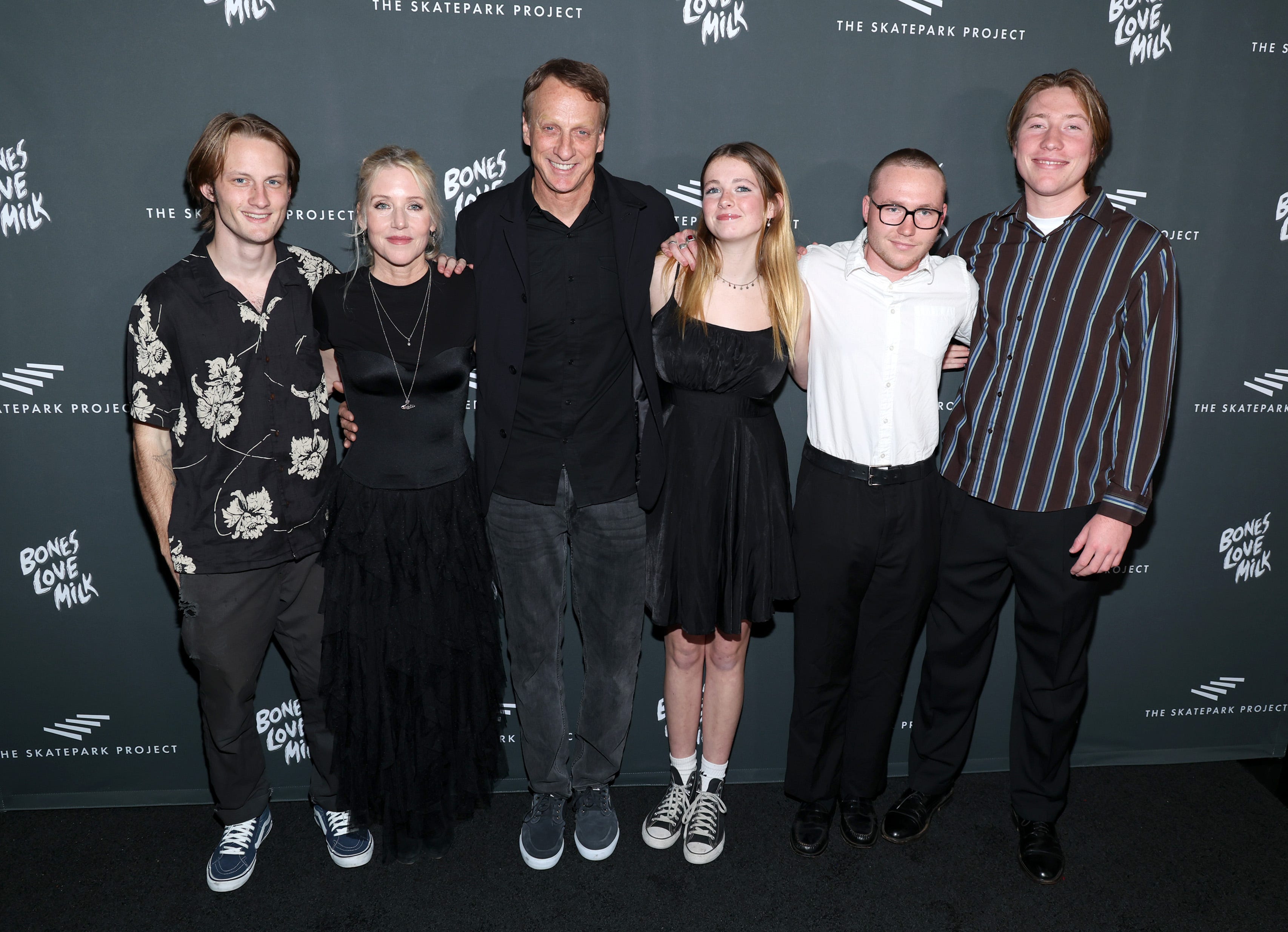 Tony Hawk poses with is wife and children on the red carpet,