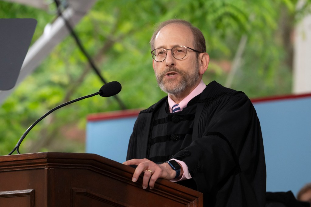 Harvard President Alan Garber speaking at a podium.