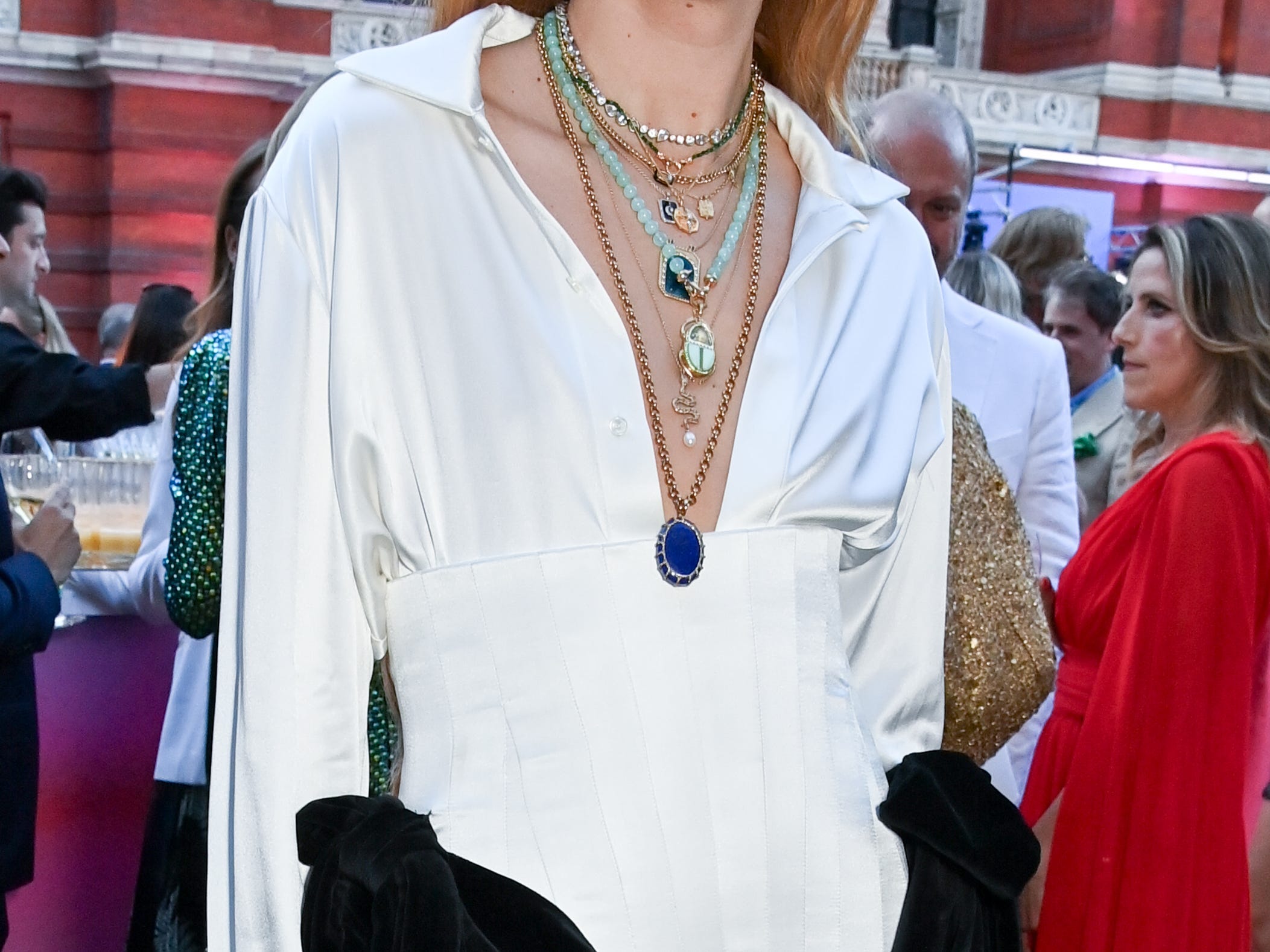 Harris Reed at an event wearing a structured black and white outfit with lots of layered necklaces