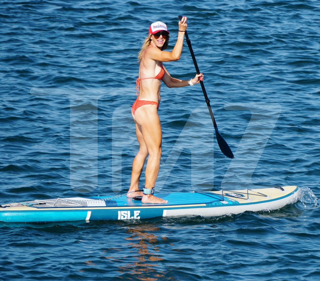 Lara Trump showed off her figure in an orange bathing suit while paddleboarding in Rhode Island on Tuesday.