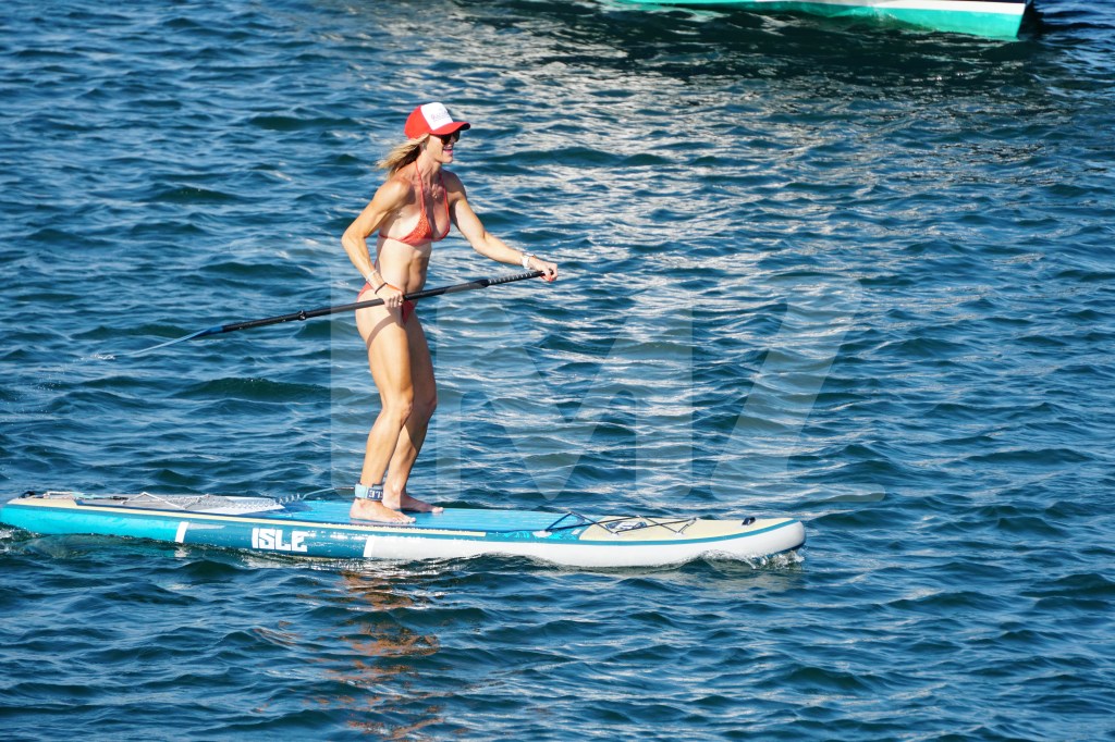 Lara Trump showed off her figure in an orange bathing suit while paddleboarding in Rhode Island on Tuesday.
