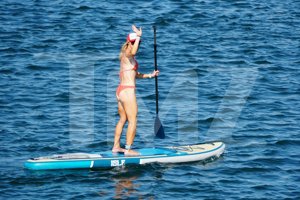 Lara Trump showed off her figure in an orange bathing suit while paddleboarding in Rhode Island on Tuesday.