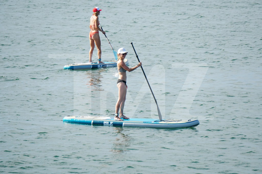 Lara Trump showed off her figure in an orange bathing suit while paddleboarding in Rhode Island on Tuesday.