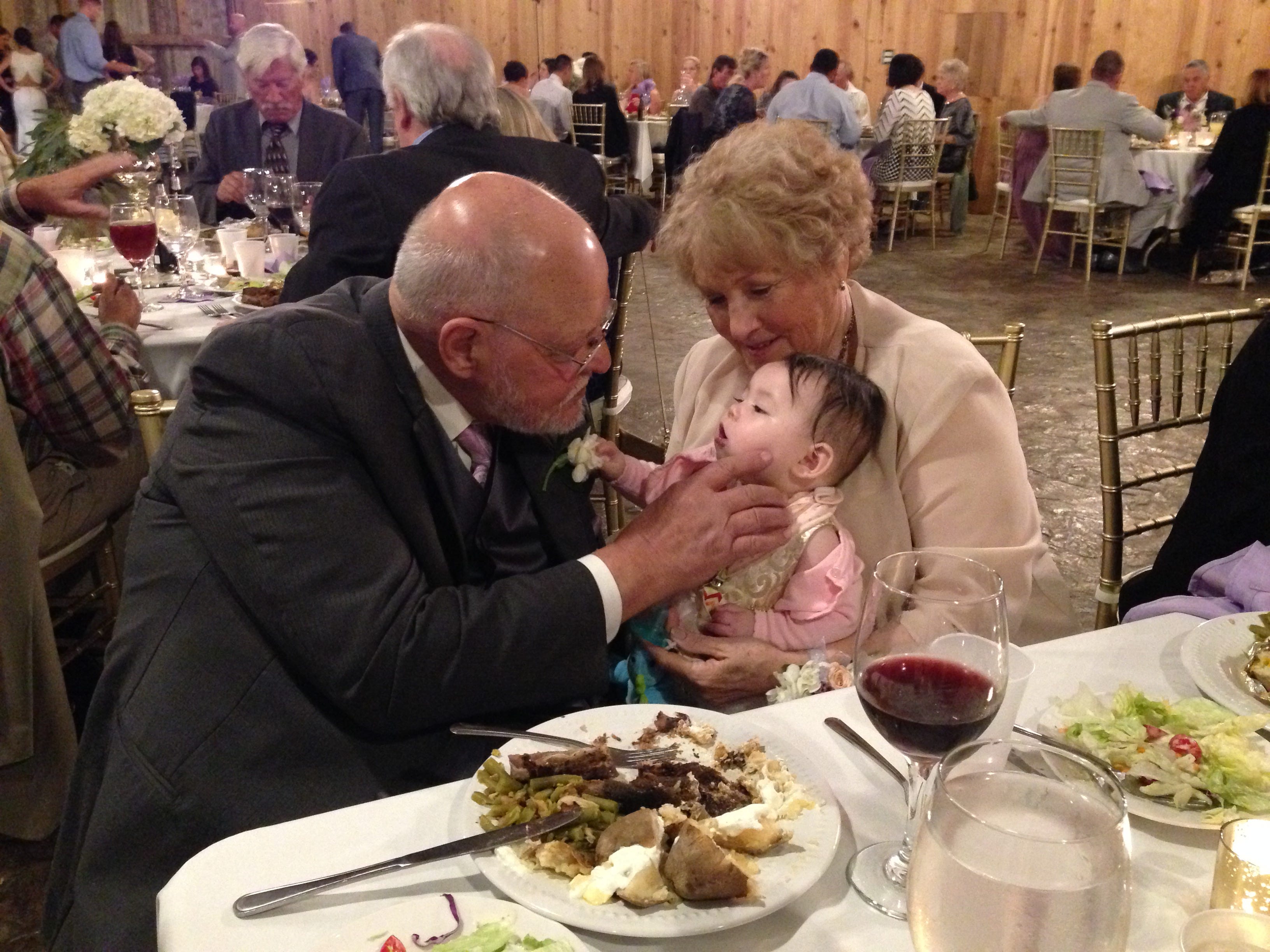 Grandparents holding baby