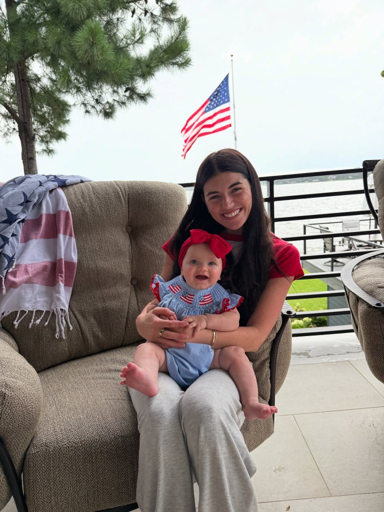 Madi Prewett holding her daughter, Hosanna, on her lap.
