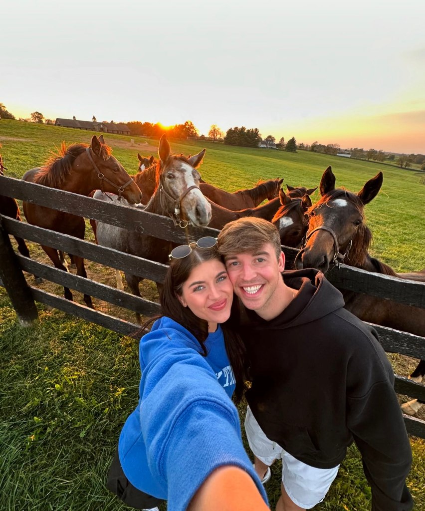 Madi Prewett and Grant Troutt taking a selfie with horses in the background.