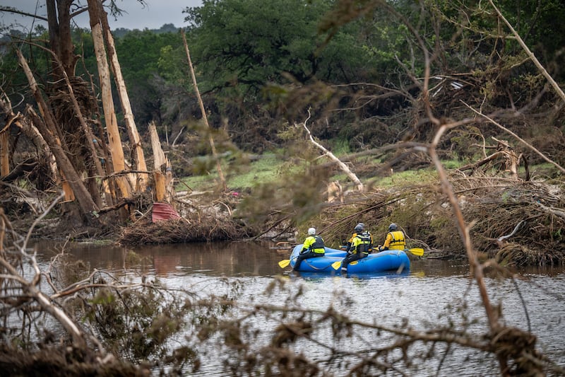 A search and recover unit paddles along the Guadalupe River on July 7, 2025 in Hunt, Texas following devastating flash floods.