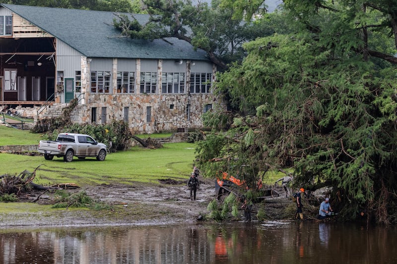 Search and recovery workers dig through debris looking for survivors—or remains of people swept up in flash flooding near Camp Mystic on July 6, 2025 in Hunt, Texas.
