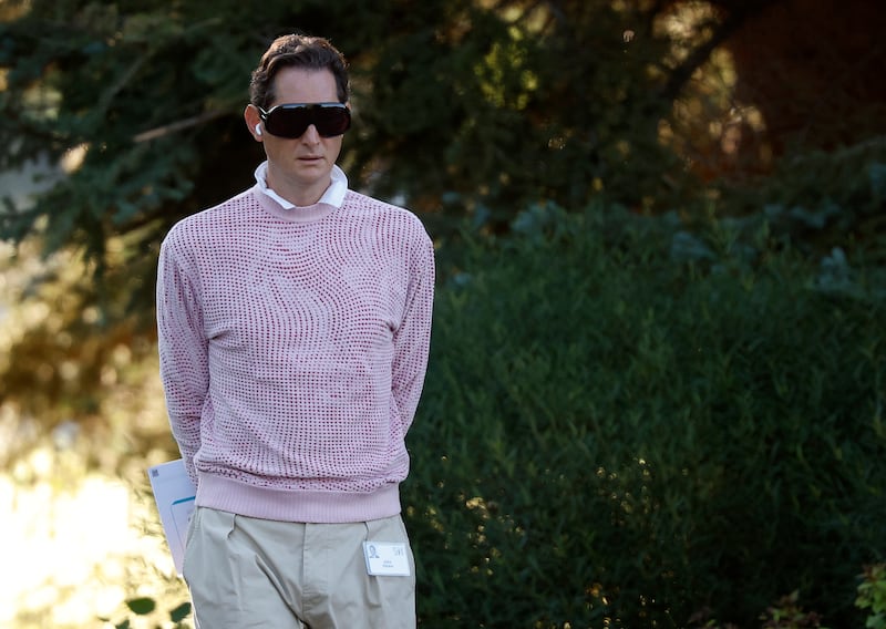 Ferrari Chairman John Elkann massive black glasses that made him look like a bug and a pink and red spotted sweatshirt as he walked to a morning session.
